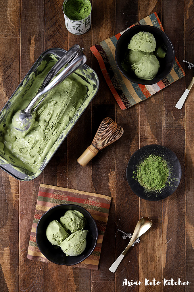 A green tea ice cream recipe served in bowls with matcha powder on a small plate and a matcha whisk.
