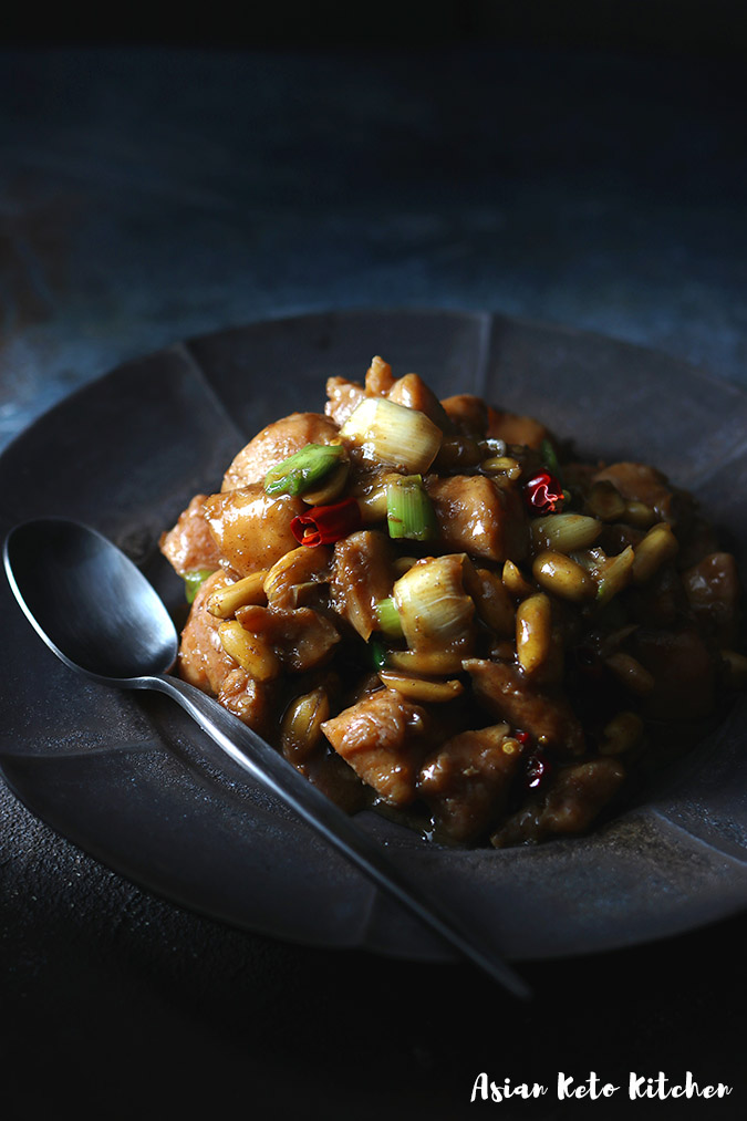 A black ceramic dish filled with Authentic Kung Pao Chicken.